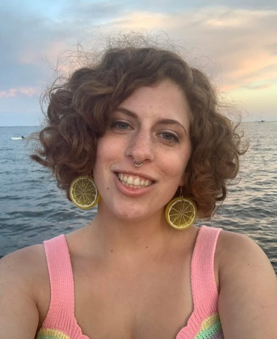 Sophia Tramuta, owner of Your Fairy Dogmother, smiling by the water